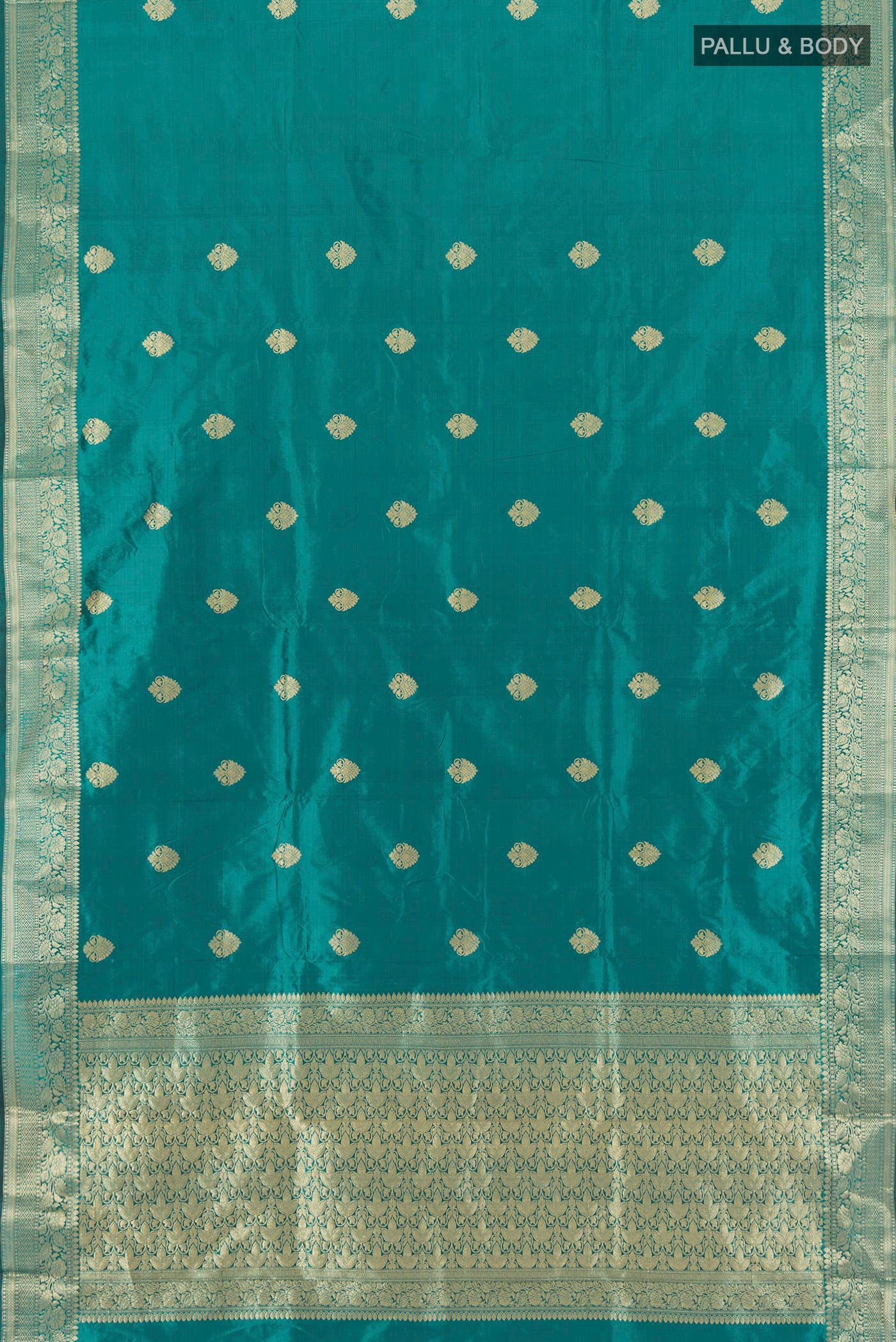 Flat view of Teal Banarasi Katan Silk Saree with Zari Butta on the body and Zari Border. 