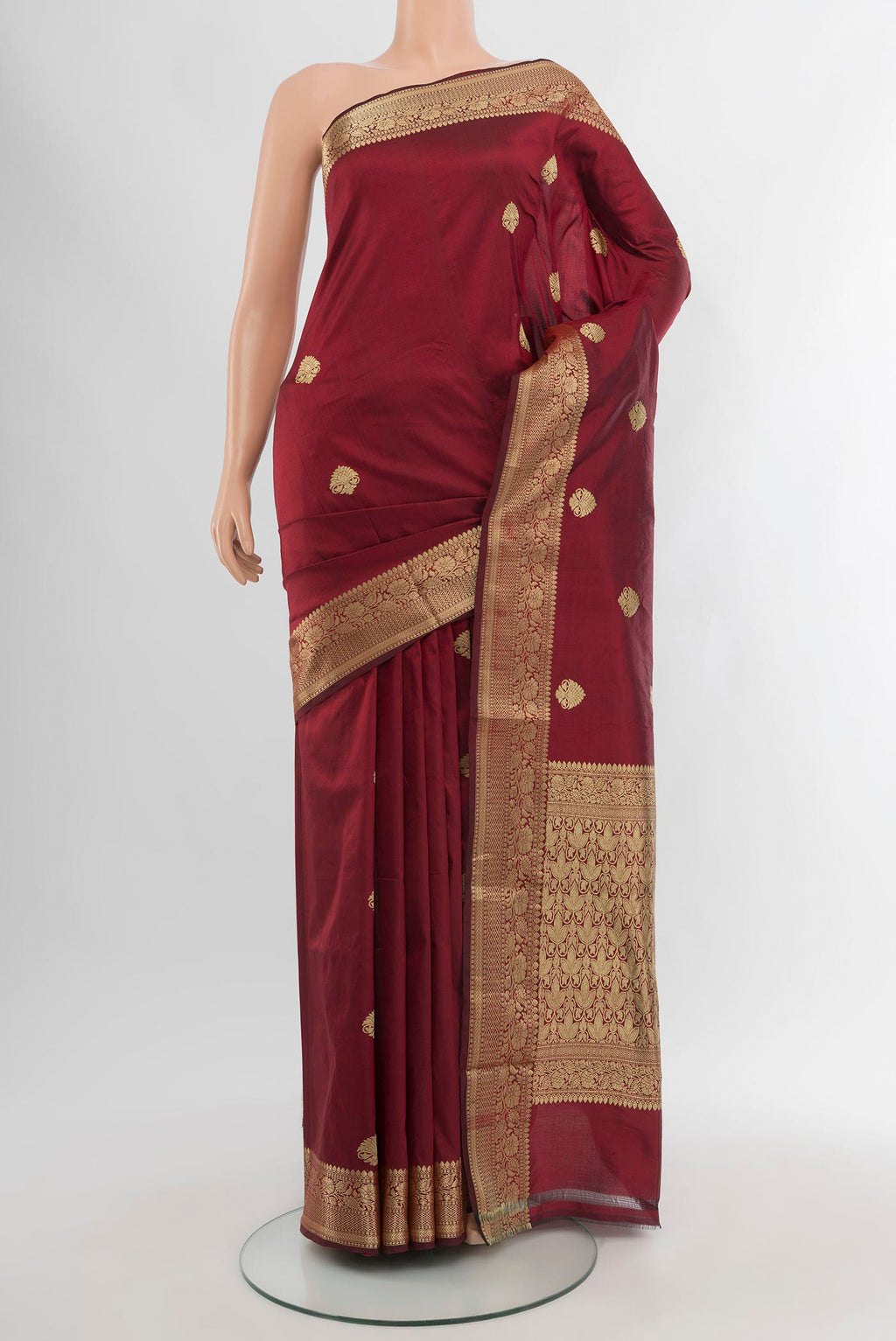 Maroon Banarasi Katan Silk Saree with Zari Butta on the body and Zari Border.  displayed on a mannequin