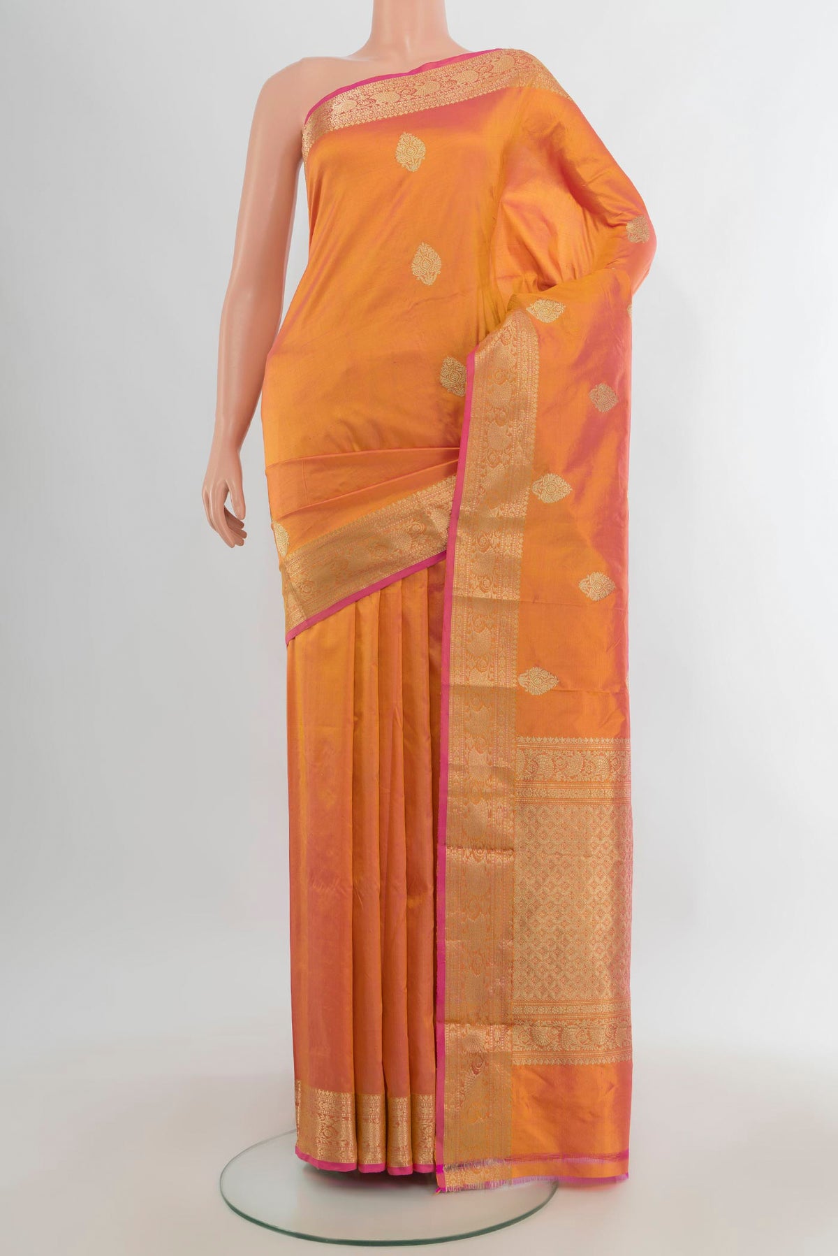 Pure Silk Golden Peach Dual Tone Banarasi Katan Saree with Zari Butta on the body and Zari Border.  displayed on a mannequin