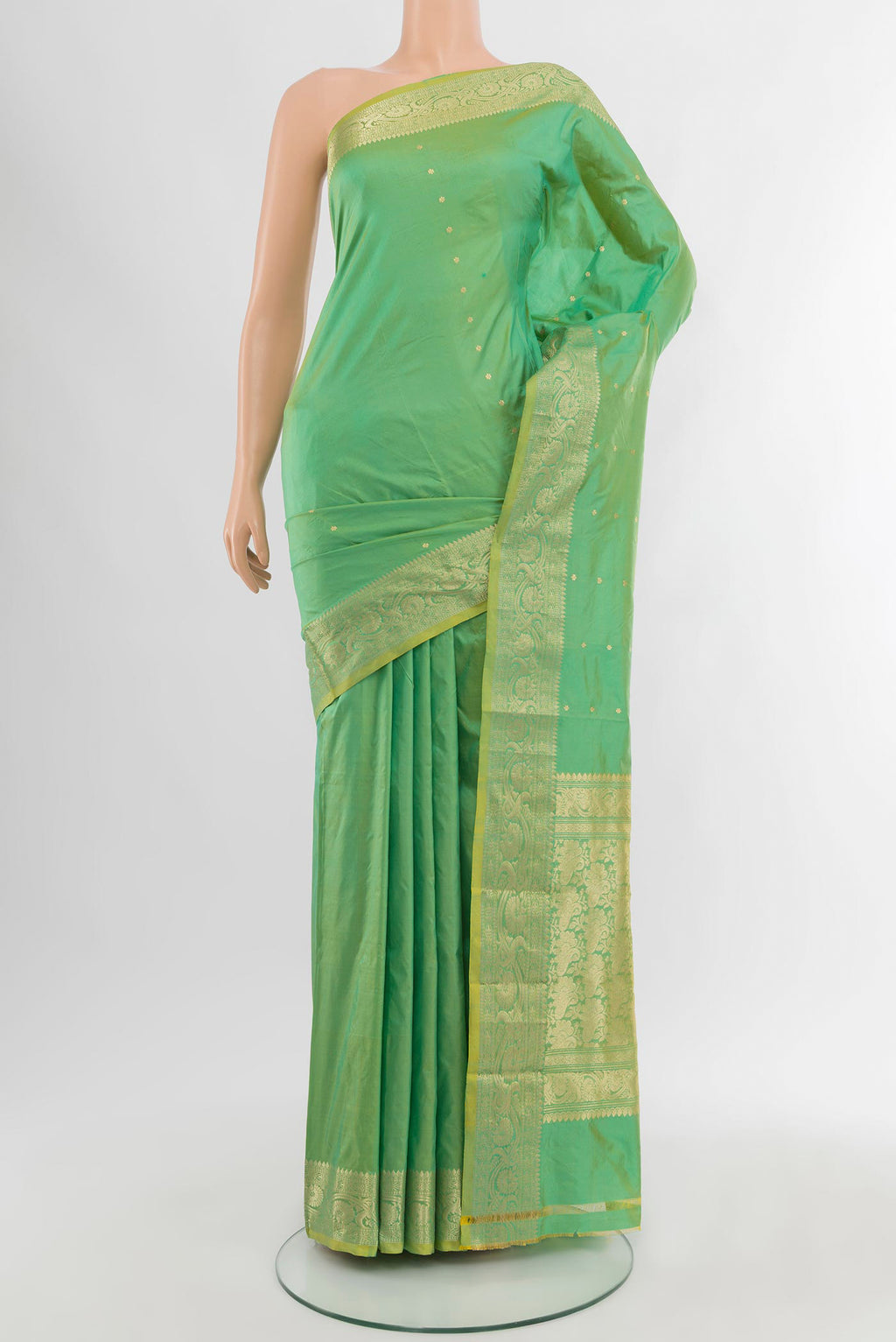 Light Green Banarasi Katan Silk Saree with Zari Butta on the body and Zari Border.  displayed on a mannequin