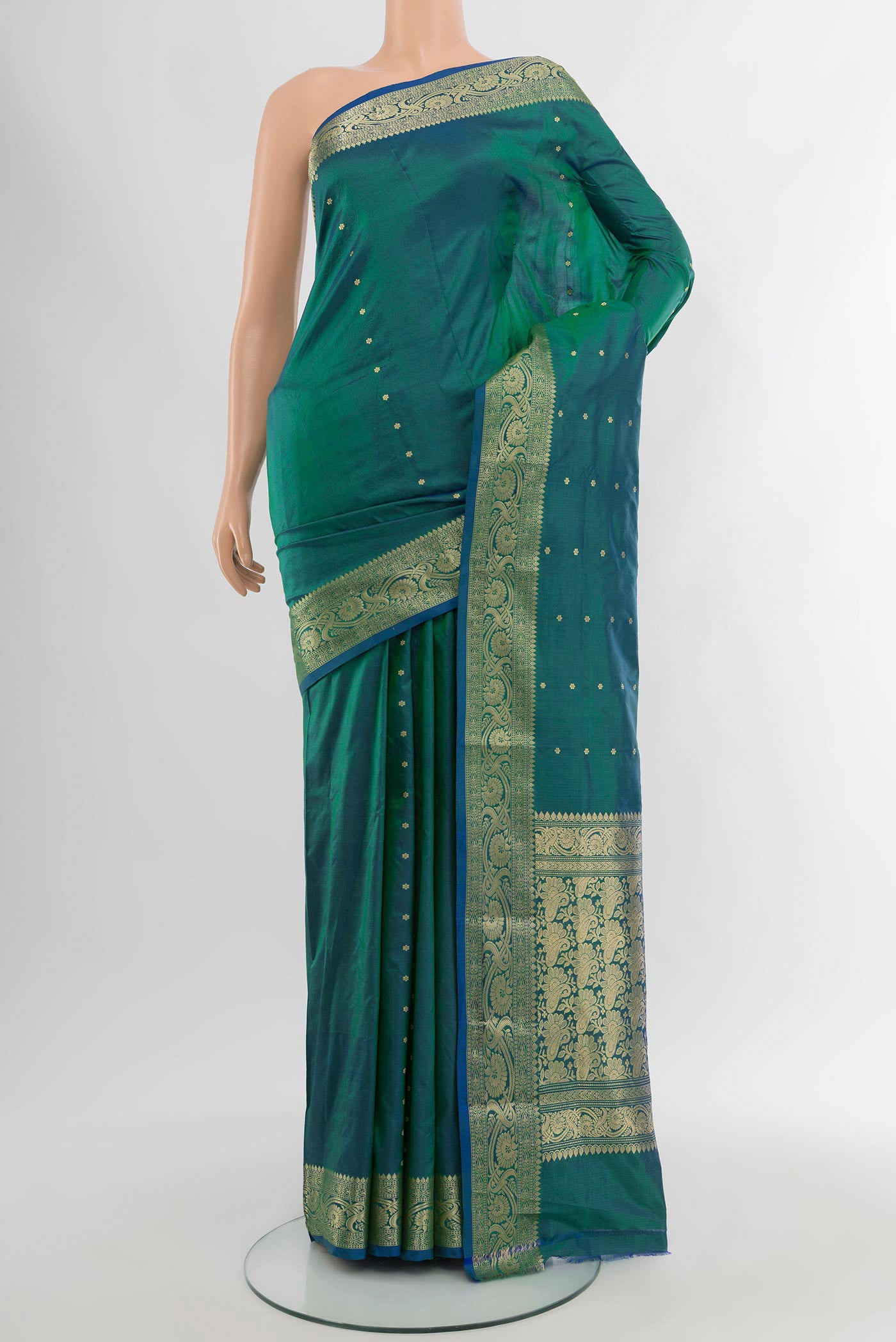 Peacock Blue Banarasi Katan Silk Saree with Zari Butta on the body and Zari Border.  displayed on a mannequin