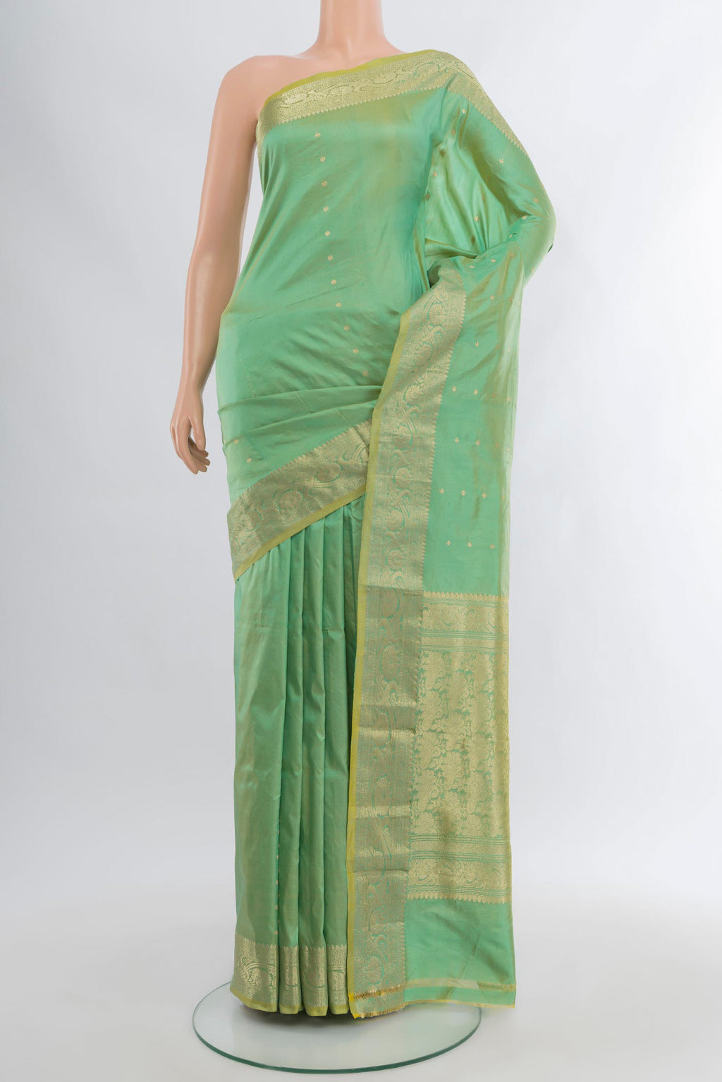 Light Green Banarasi Katan Silk Saree with Zari Butta on the body and Zari Border.  displayed on a mannequin
