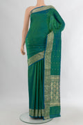 Pure Silk Peacock Blue Dual Tone Banarasi Katan Saree with Zari Butta on the body and Zari Border.  displayed on a mannequin