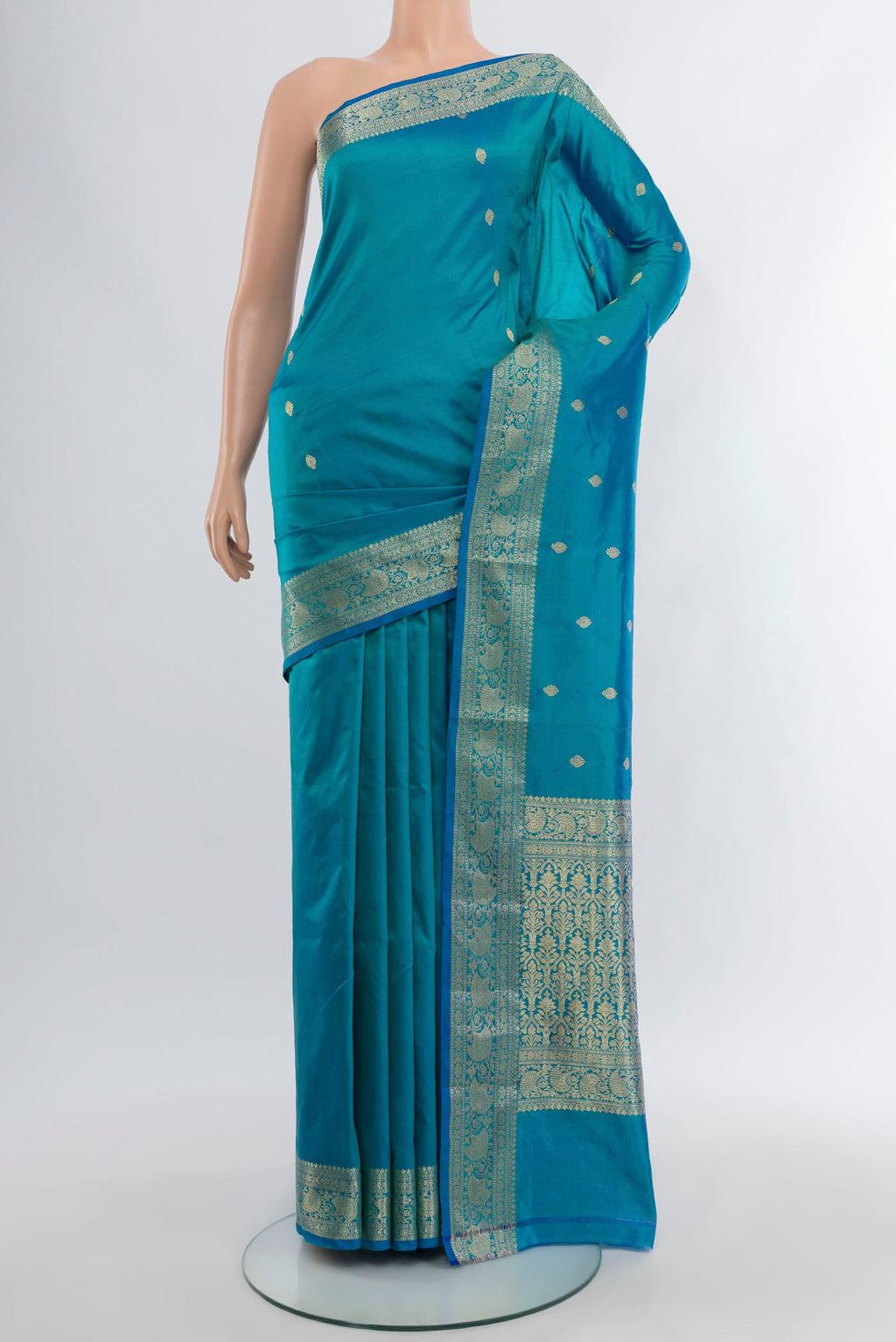 Blue Banarasi Katan Silk Saree with Zari Butta on the body and Zari Border.  displayed on a mannequin