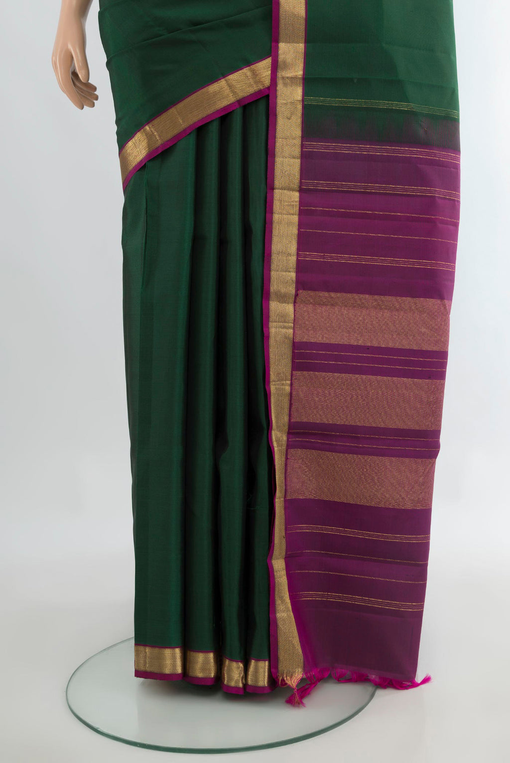 Pleats and pallu of Pure Silk Bottle Green Kanjivaram Saree with Plain Body and Zari Border. 