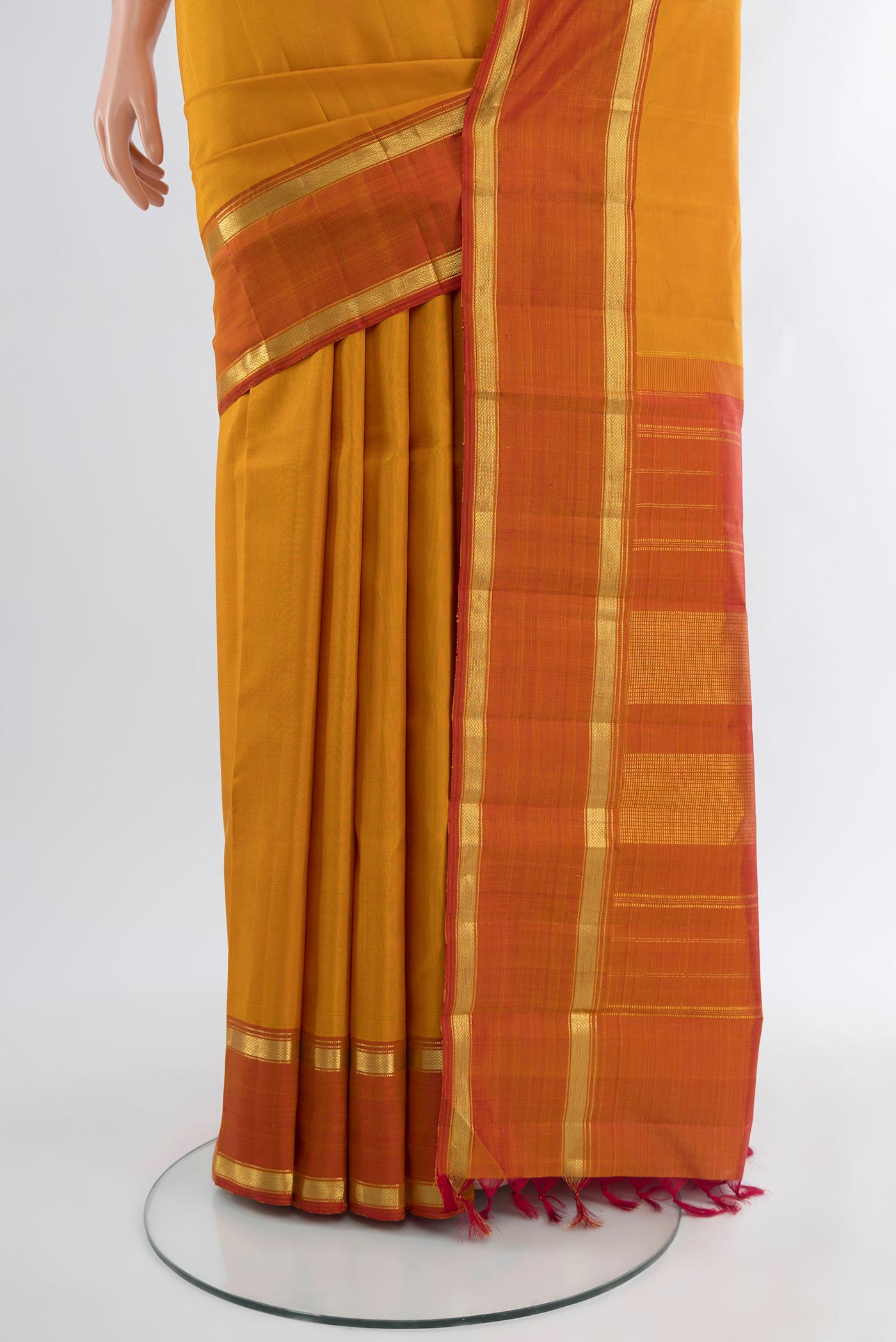 Pleats and pallu of Mustard Kanjivaram Silk Saree with Plain Body and Zari Border. 