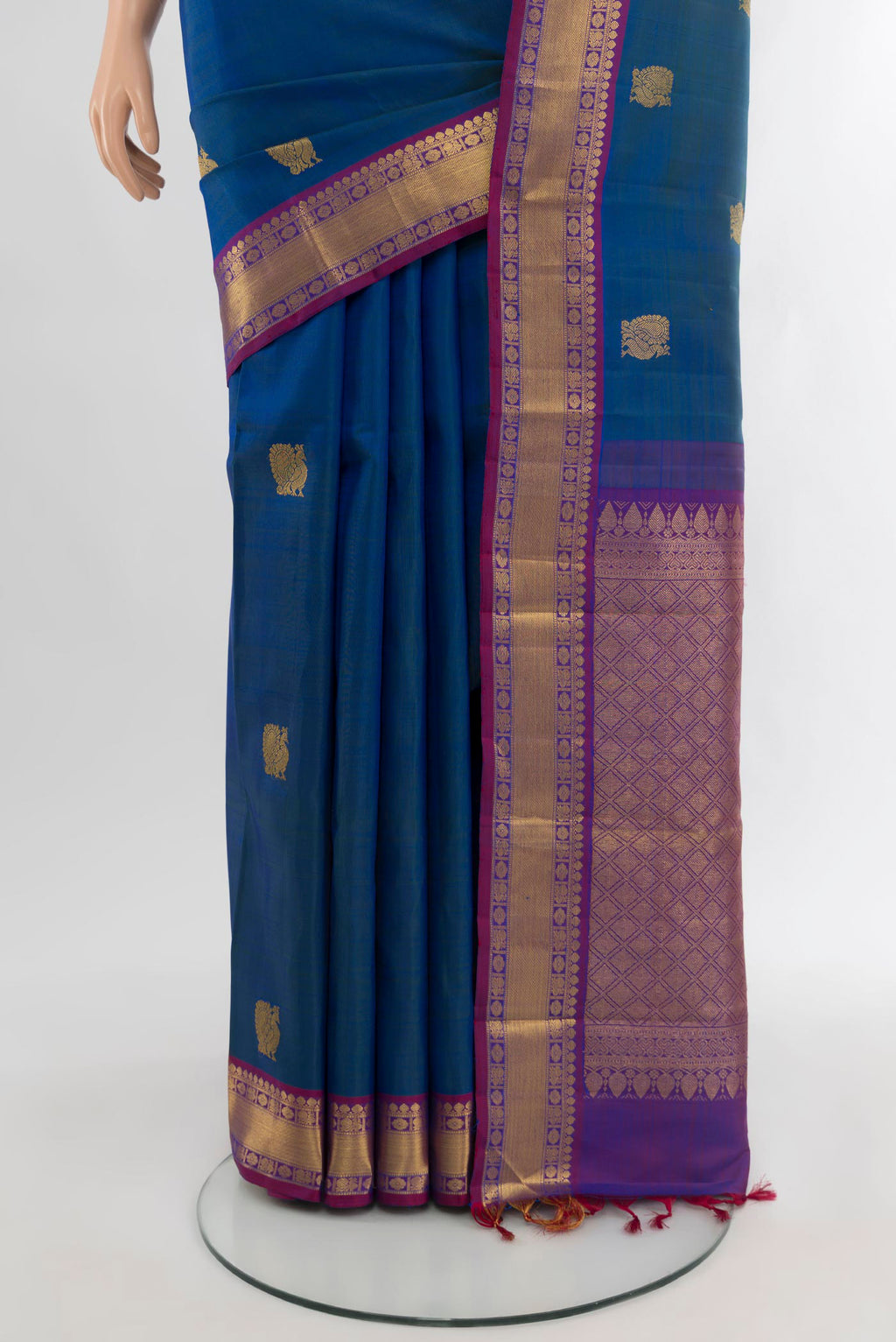 Pleats and pallu of Peacock Blue Kanjivaram Silk Saree with Zari Butta on the body and Zari Border. 