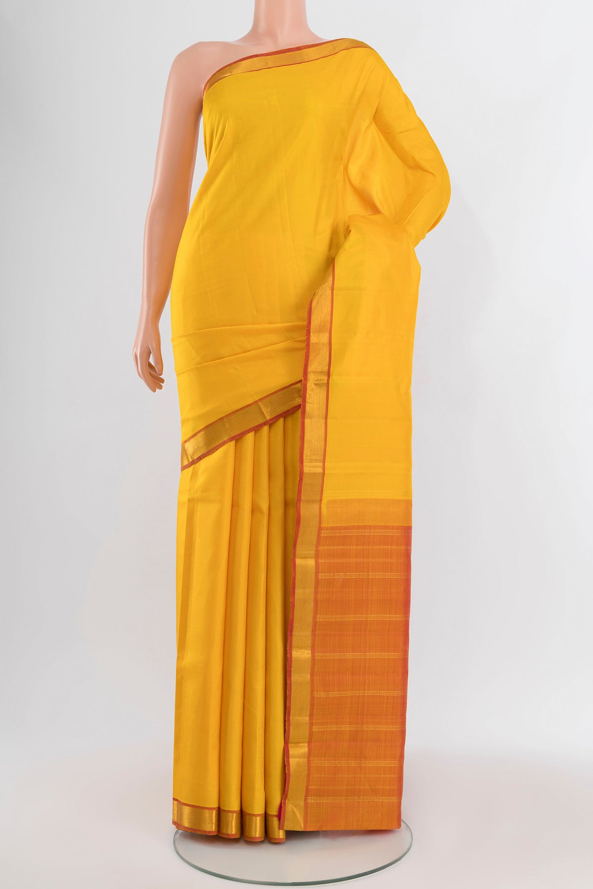 Yellow Kanjivaram Silk Saree with Plain Body and Zari Border.  displayed on a mannequin