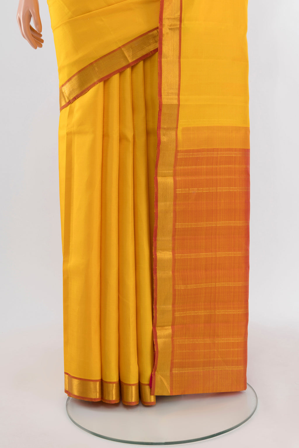 Pleats and pallu of Yellow Kanjivaram Silk Saree with Plain Body and Zari Border. 