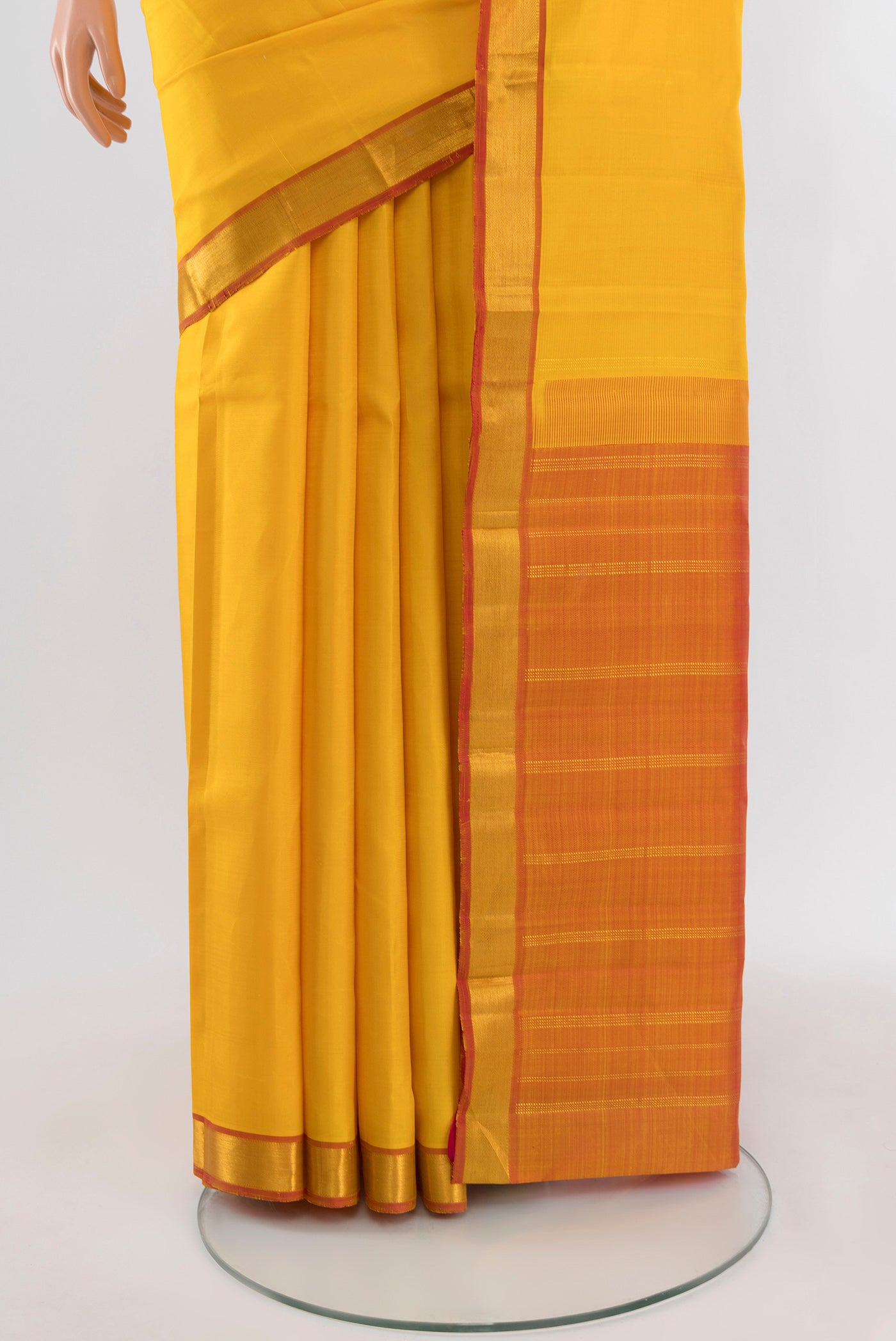 Pleats and pallu of Yellow Kanjivaram Silk Saree with Plain Body and Zari Border. 