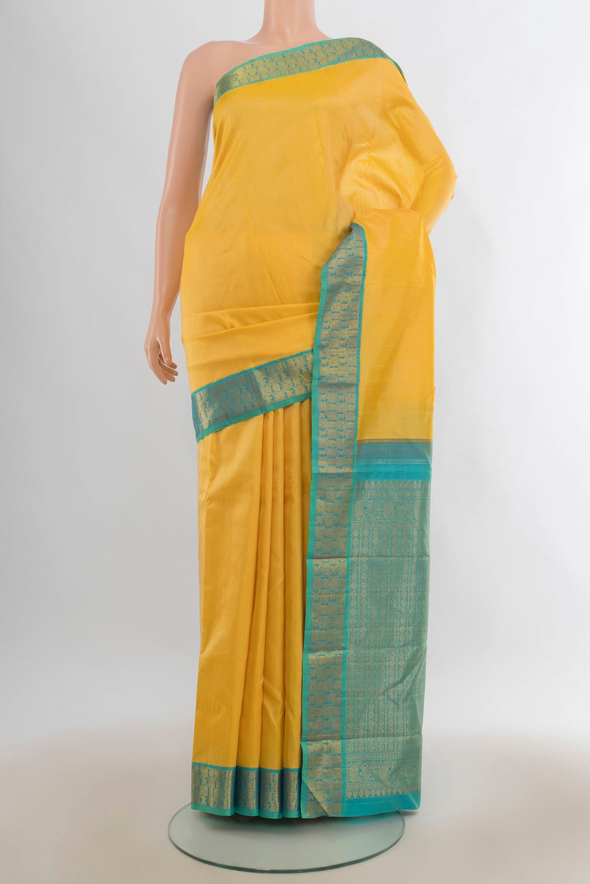 Pure Silk Yellow Kanjivaram Saree with Zari Butta on the body and Zari Border.  displayed on a mannequin