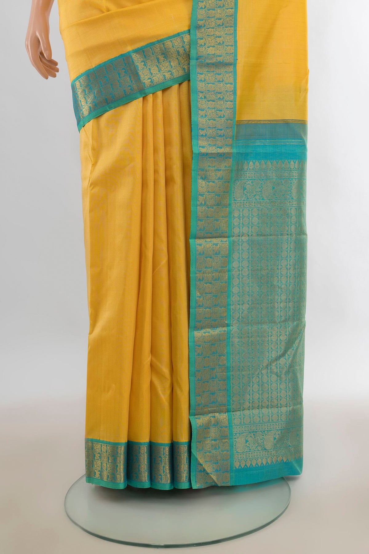 Pleats and pallu of Pure Silk Yellow Kanjivaram Saree with Zari Butta on the body and Zari Border. 