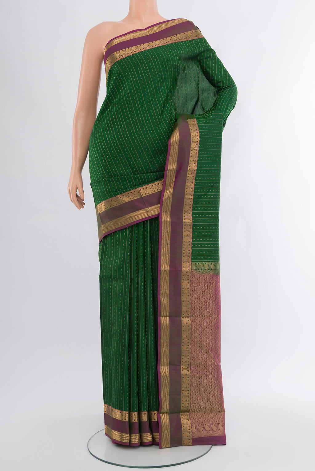 Green Kanchipuram Silk Saree with Zari Butta on the body and Zari Border.  displayed on a mannequin