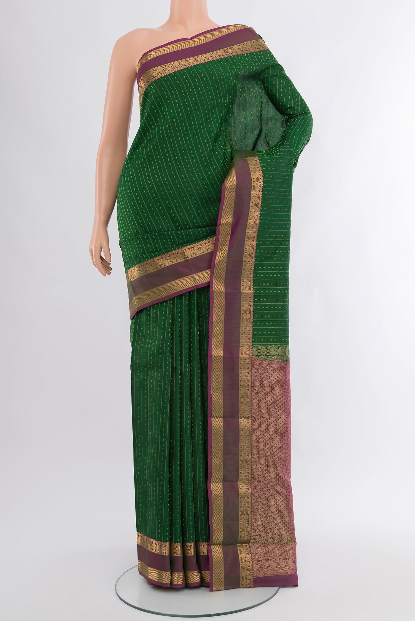 Green Kanchipuram Silk Saree with Zari Butta on the body and Zari Border.  displayed on a mannequin