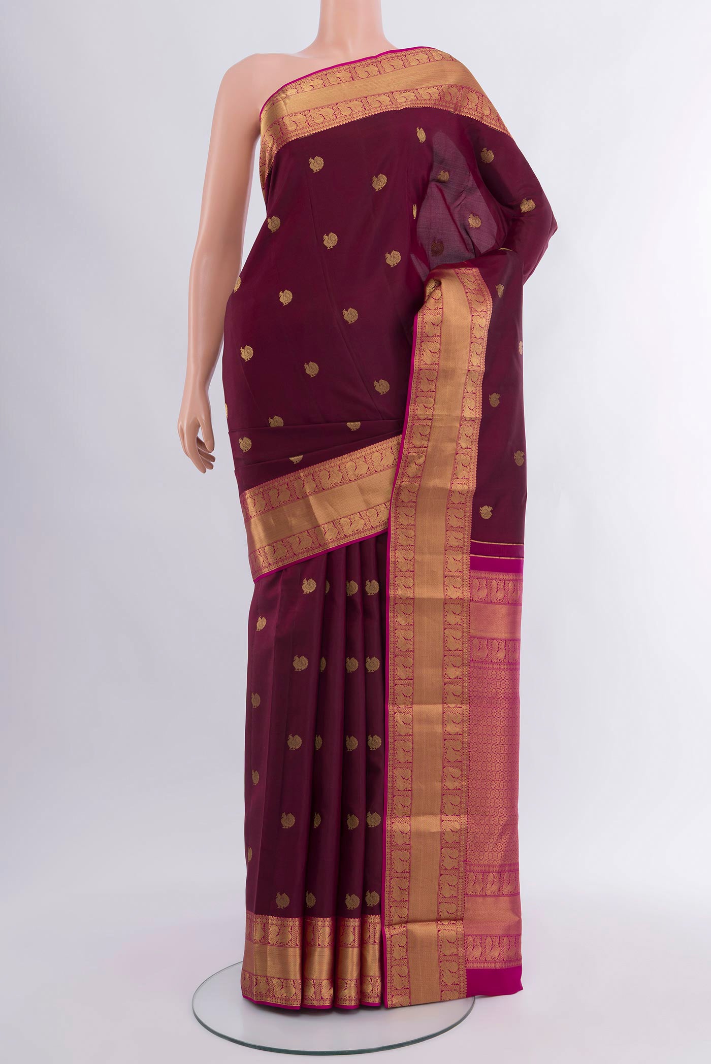 Coffee Brown Kanjivaram Silk Saree with Zari Butta on the body and Zari Border.  displayed on a mannequin