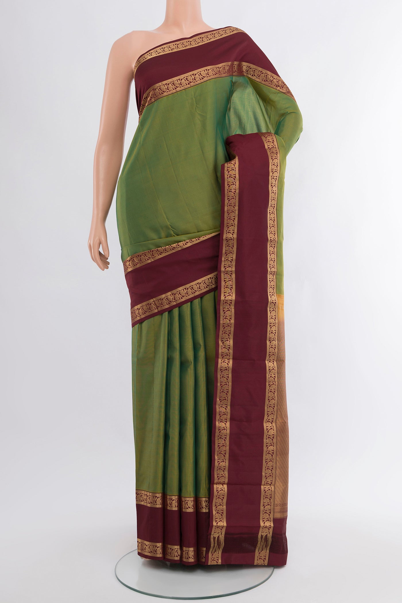 Light Green Kanchipuram Silk Saree with Plain Body and Zari Border.  displayed on a mannequin
