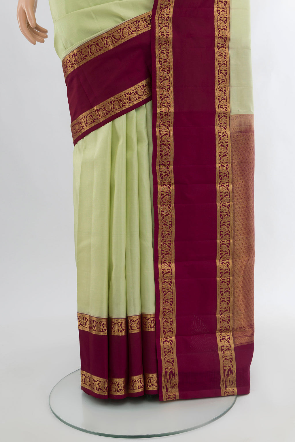 Pleats and pallu of Pista Green Kanchipuram Silk Saree with Plain Body and Zari Border. 