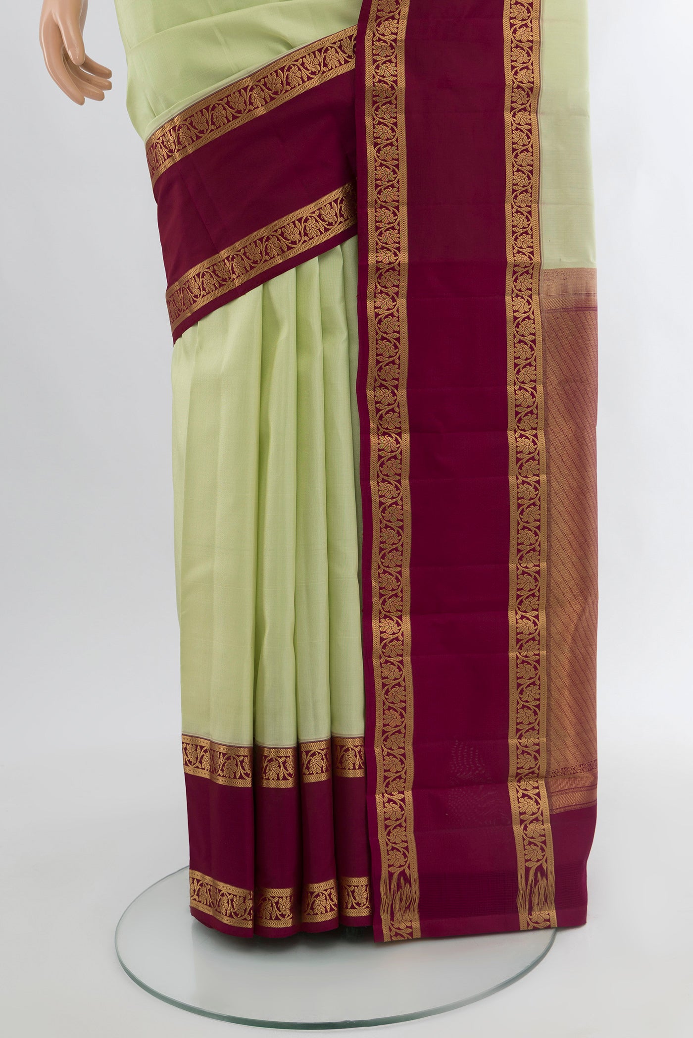 Pleats and pallu of Pista Green Kanchipuram Silk Saree with Plain Body and Zari Border. 