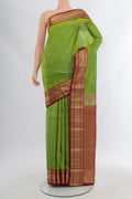 Green Kanchipuram Silk Saree with Zari Butta on the body and Zari Border.  displayed on a mannequin