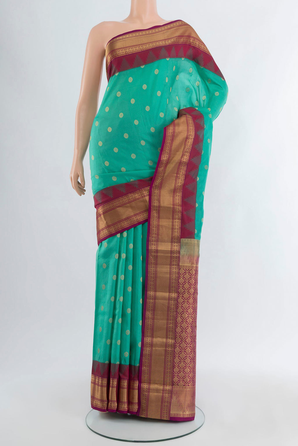 Sea Green Kanchipuram Silk Saree with Zari Butta on the body and Zari Border.  displayed on a mannequin
