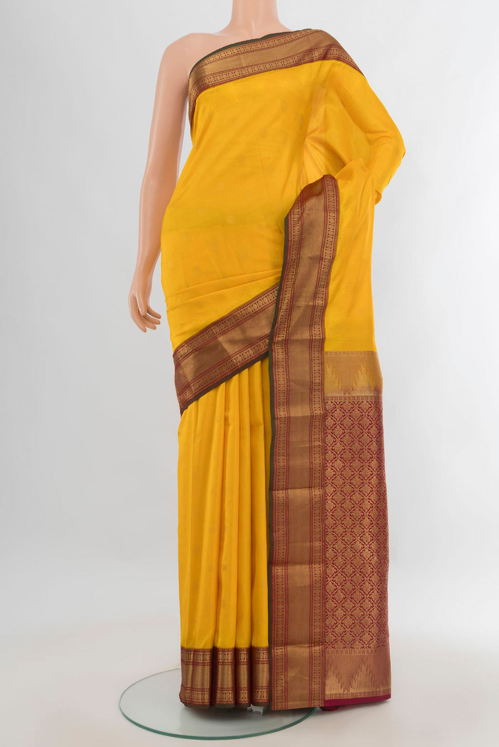 Pure Silk Yellow Kanchipuram Saree with Zari Butta on the body and Zari Border.  displayed on a mannequin