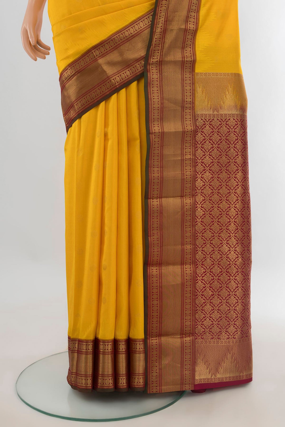 Pleats and pallu of Pure Silk Yellow Kanchipuram Saree with Zari Butta on the body and Zari Border. 