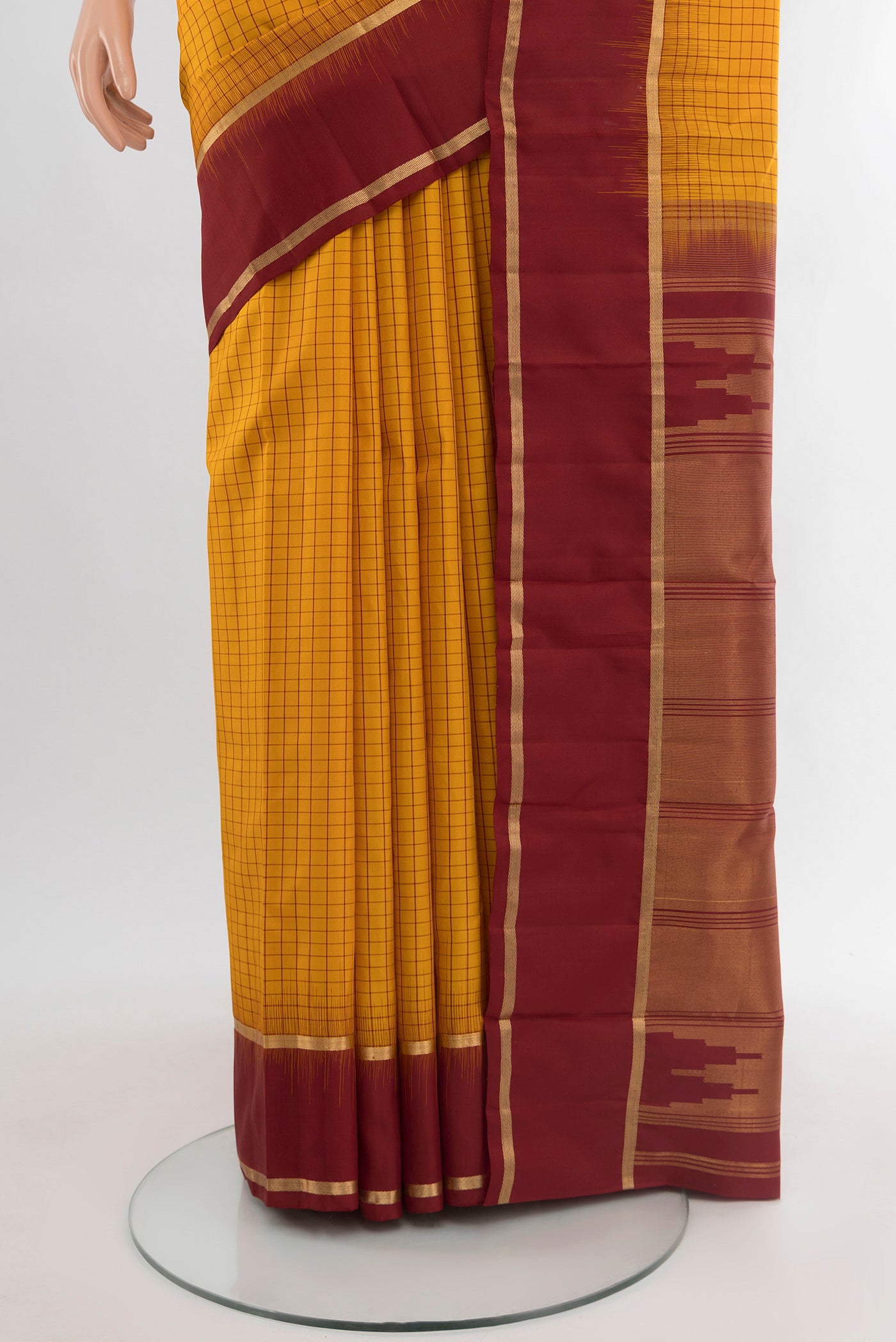 Pleats and pallu of Mustard Kanchipuram Silk Saree with Checked design on the body and Plain Border. 