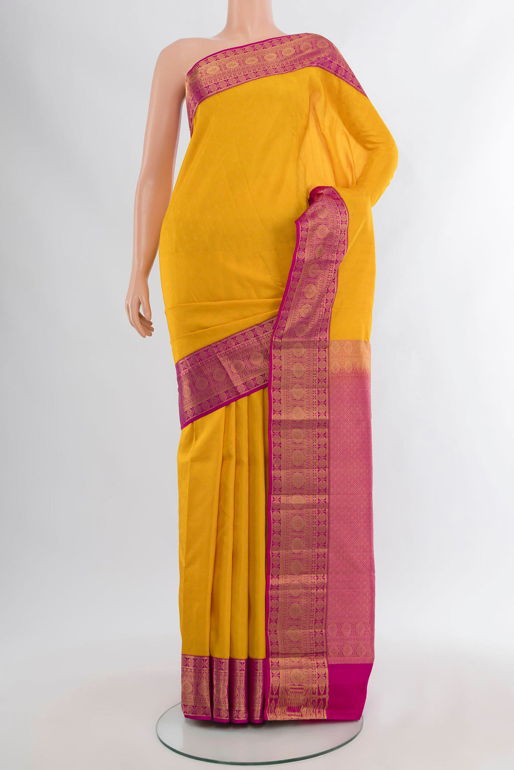 Yellow Kanchipuram Silk Saree with Zari Butta on the body and Zari Border.  displayed on a mannequin