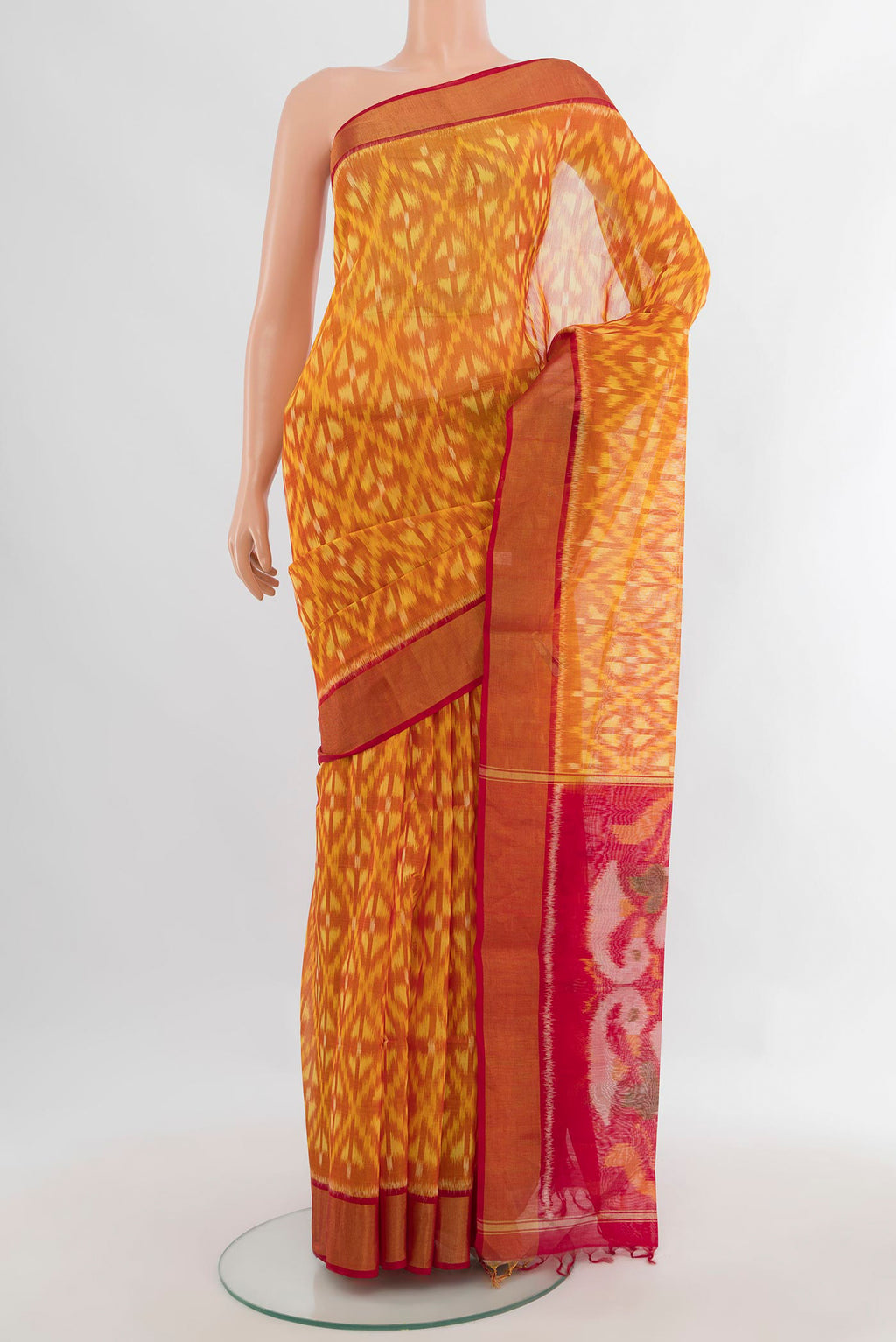 Yellow Silk Cotton Saree with Ikat design on the body and Zari Border.  displayed on a mannequin