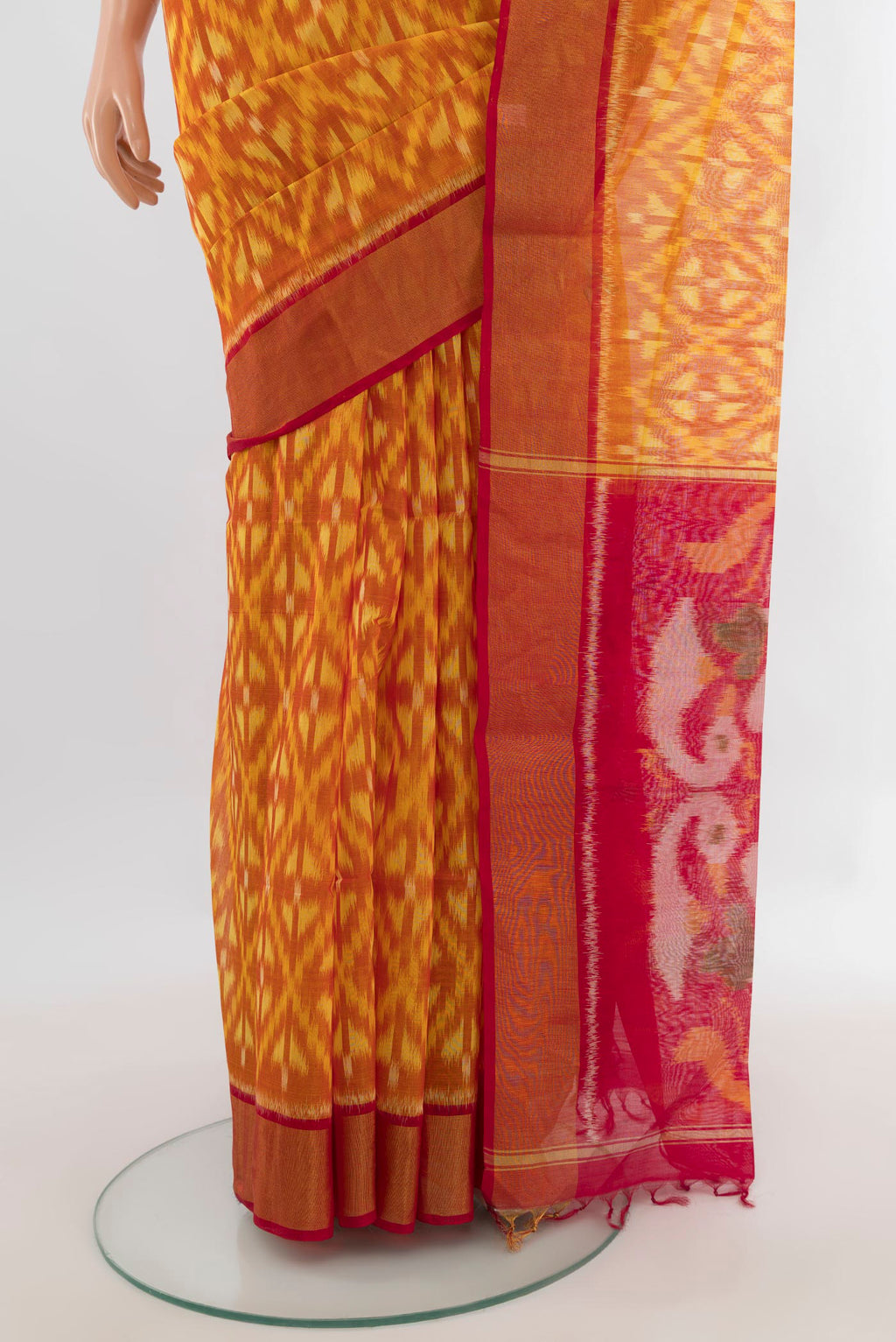 Pleats and pallu of Yellow Silk Cotton Saree with Ikat design on the body and Zari Border. 