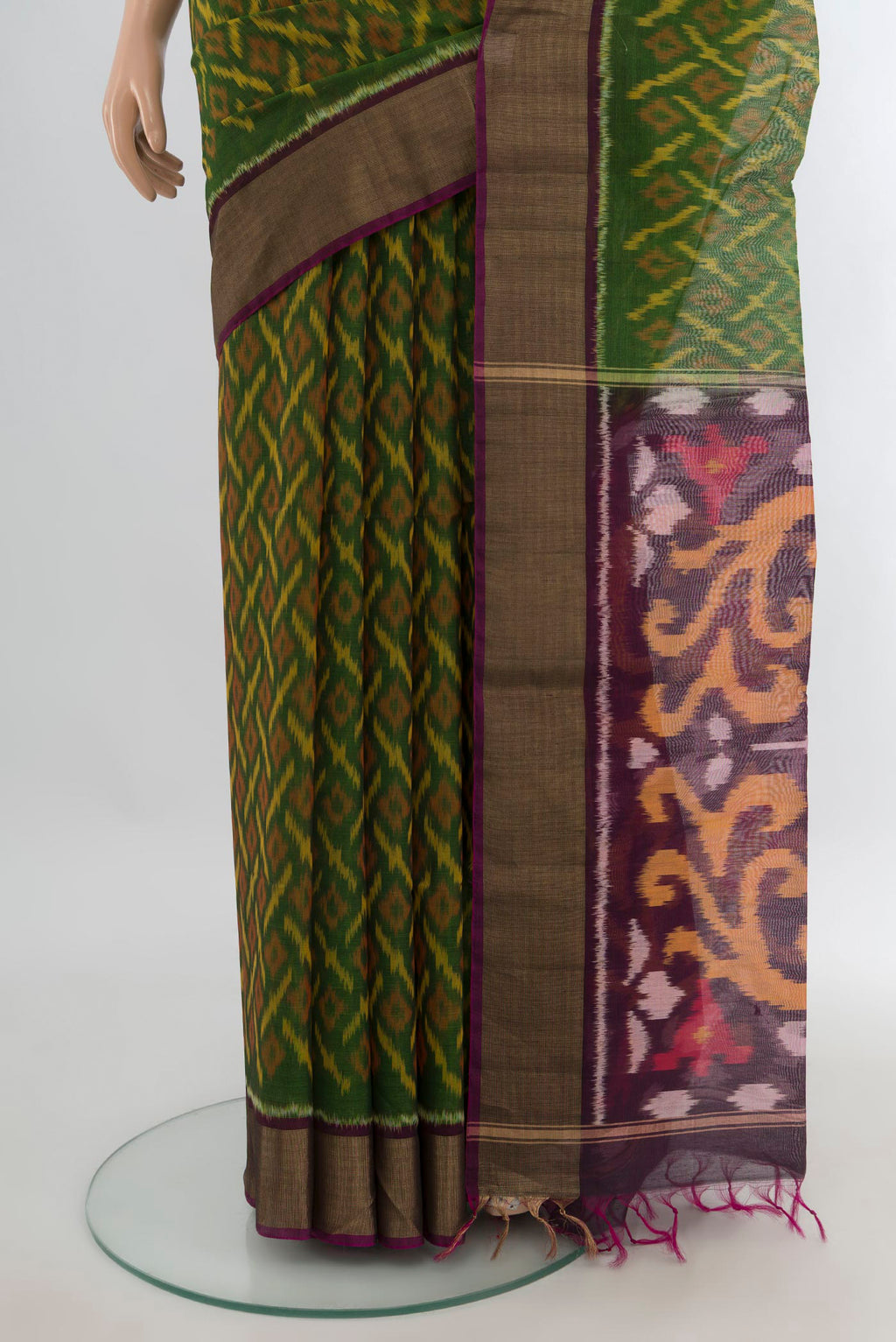 Pleats and pallu of Green Silk Cotton Saree with Ikat Print on the body and Zari Border. 