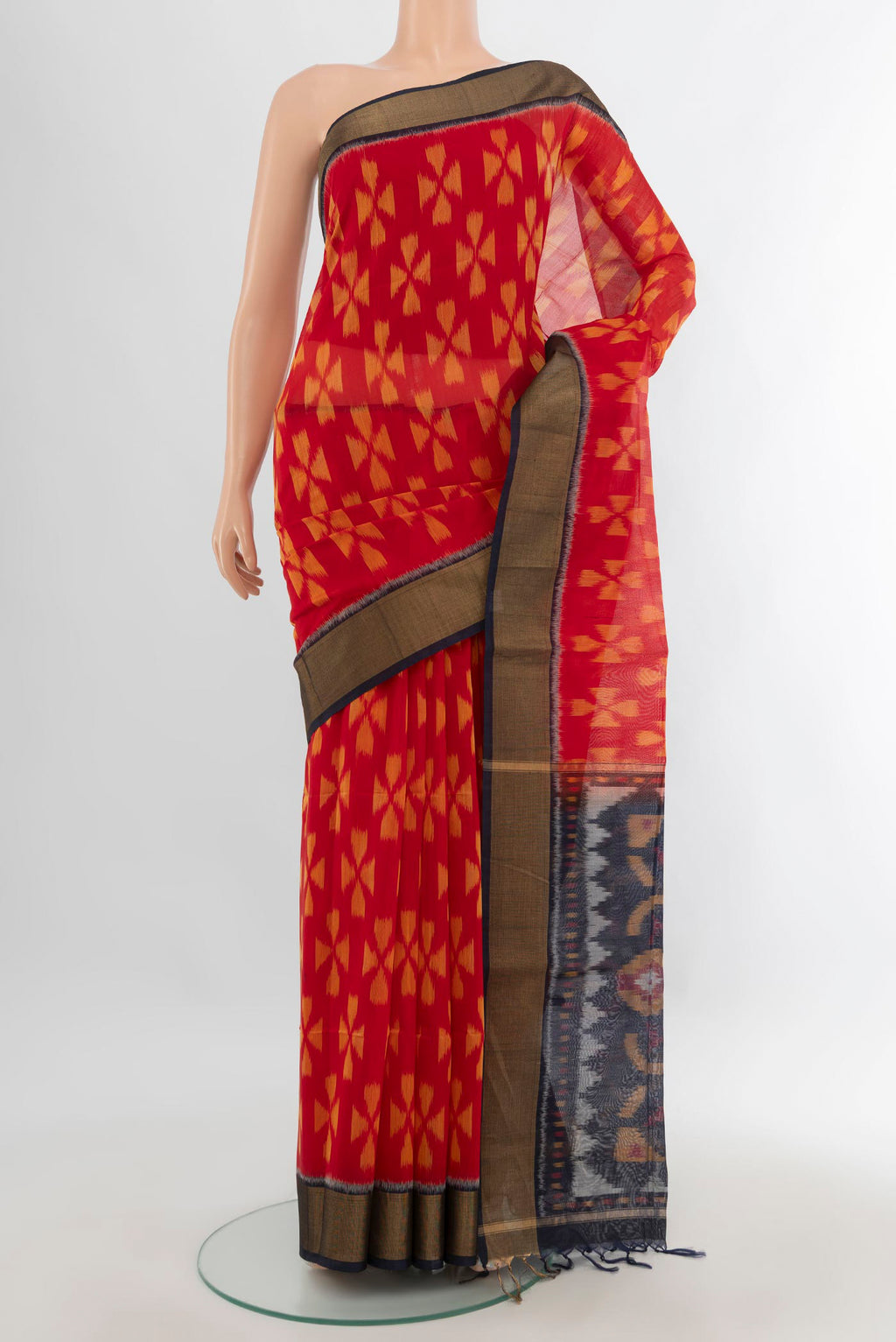 Red Silk Cotton Saree with Ikat Print on the body and Zari Border.  displayed on a mannequin