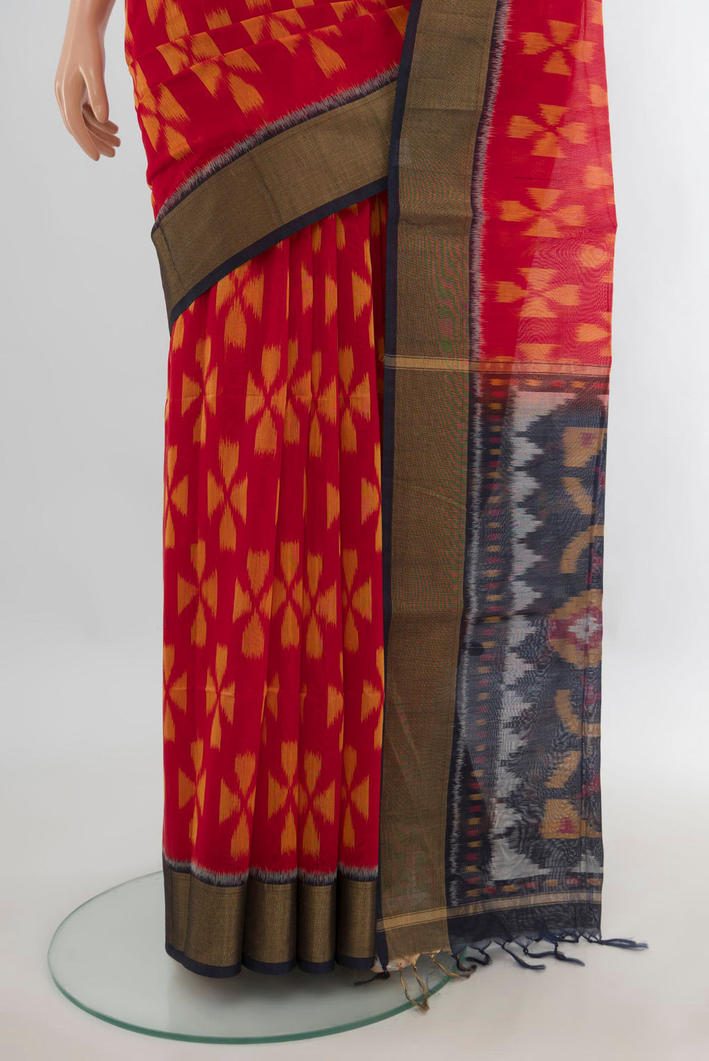 Pleats and pallu of Red Silk Cotton Saree with Ikat Print on the body and Zari Border. 