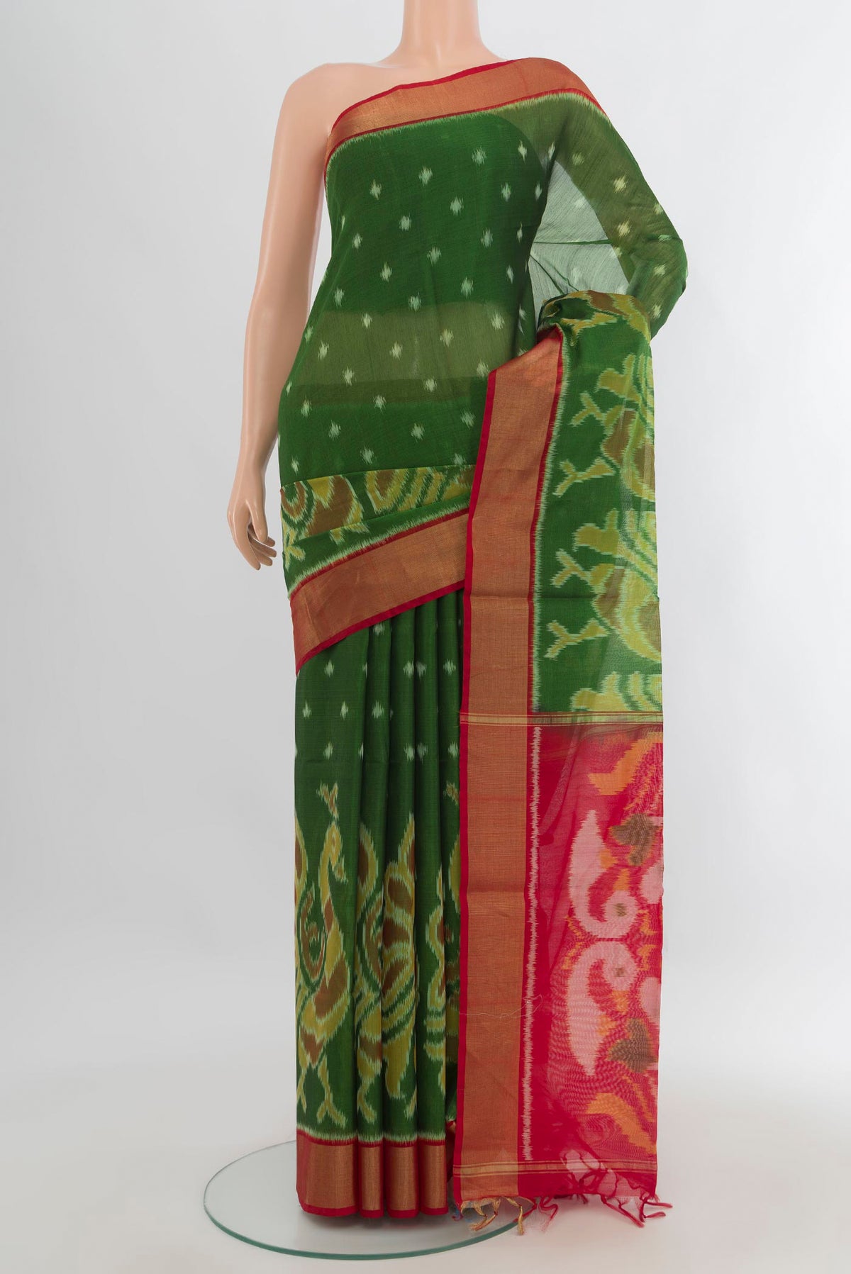 Green Silk Cotton Saree with Ikat Print on the body and Zari Border.  displayed on a mannequin