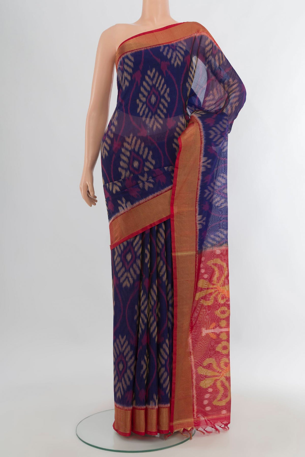 Navy Blue Silk Cotton Saree with Ikat Print on the body and Zari Border.  displayed on a mannequin