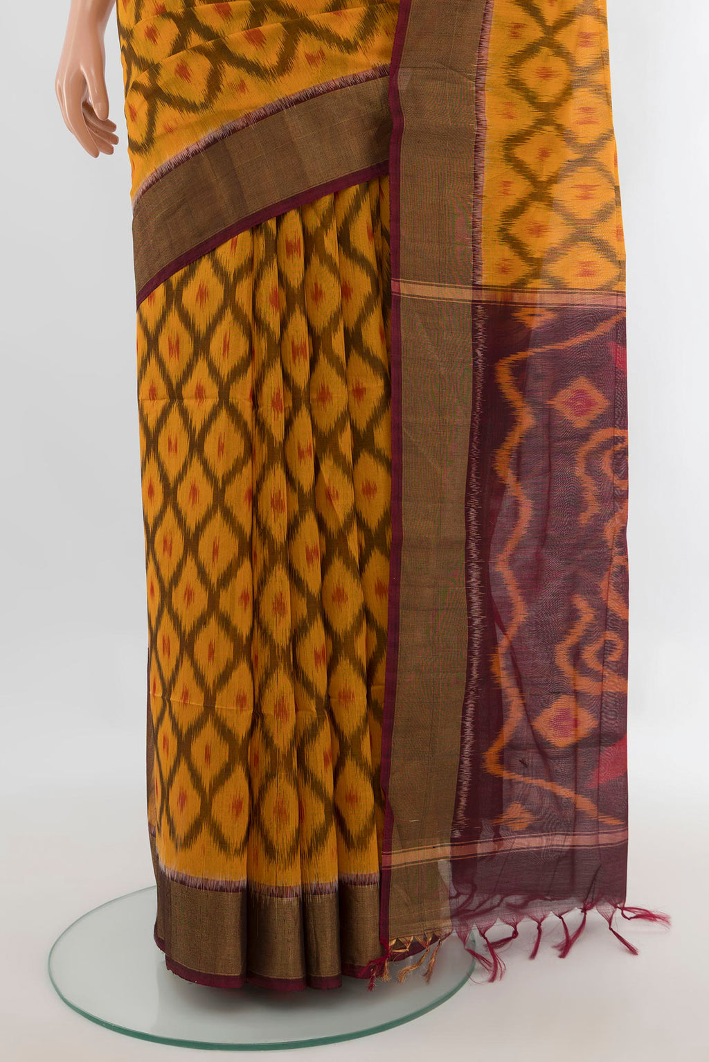 Pleats and pallu of Yellow Silk Cotton Saree with Ikat design on the body and Zari Border. 