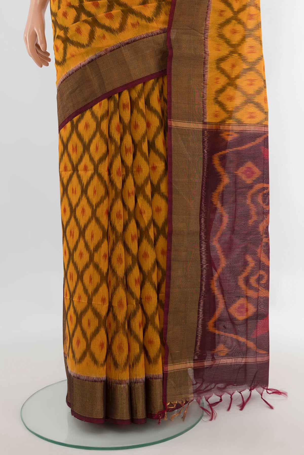 Pleats and pallu of Yellow Silk Cotton Saree with Ikat design on the body and Zari Border. 