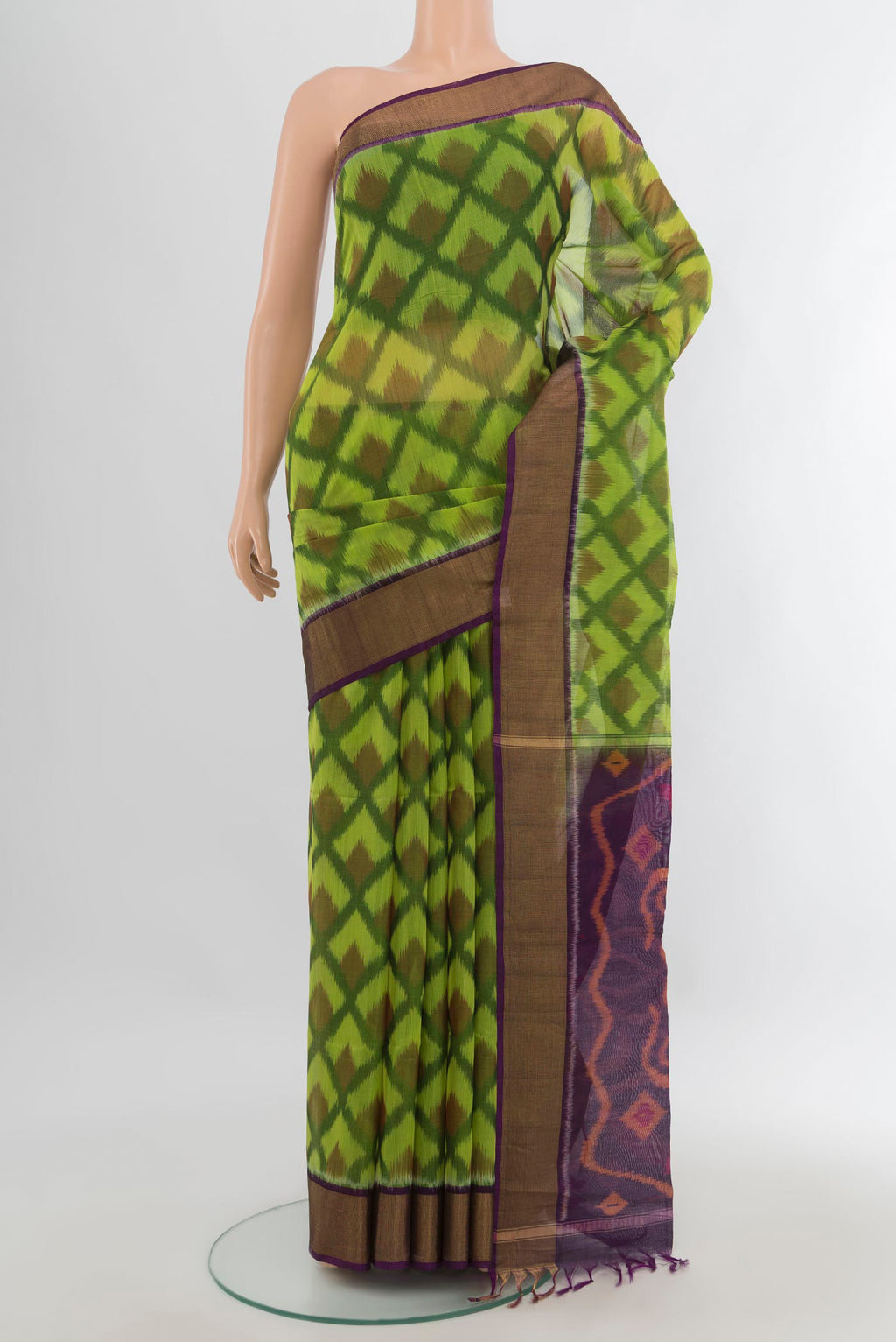 Parrot Green Silk Cotton Saree with Ikat Print on the body and Zari Border.  displayed on a mannequin