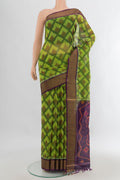 Parrot Green Silk Cotton Saree with Ikat Print on the body and Zari Border.  displayed on a mannequin