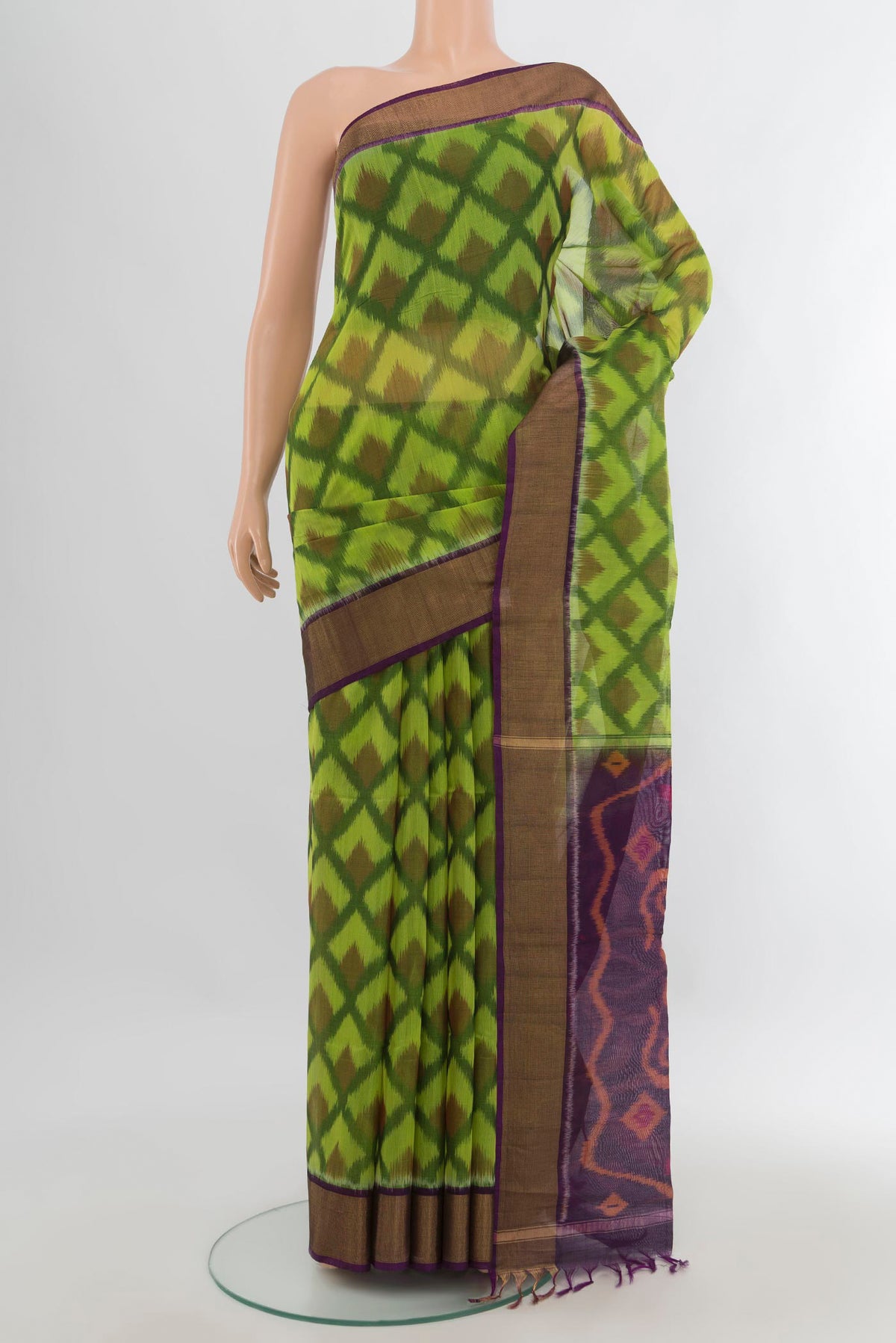 Parrot Green Silk Cotton Saree with Ikat Print on the body and Zari Border.  displayed on a mannequin