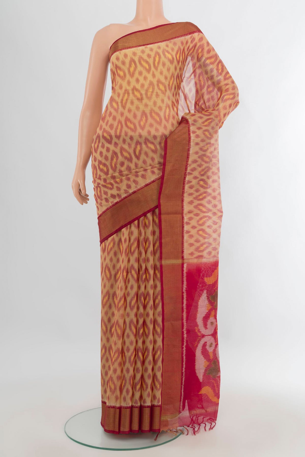 Sandal Silk Cotton Saree with Ikat Print on the body and Zari Border.  displayed on a mannequin