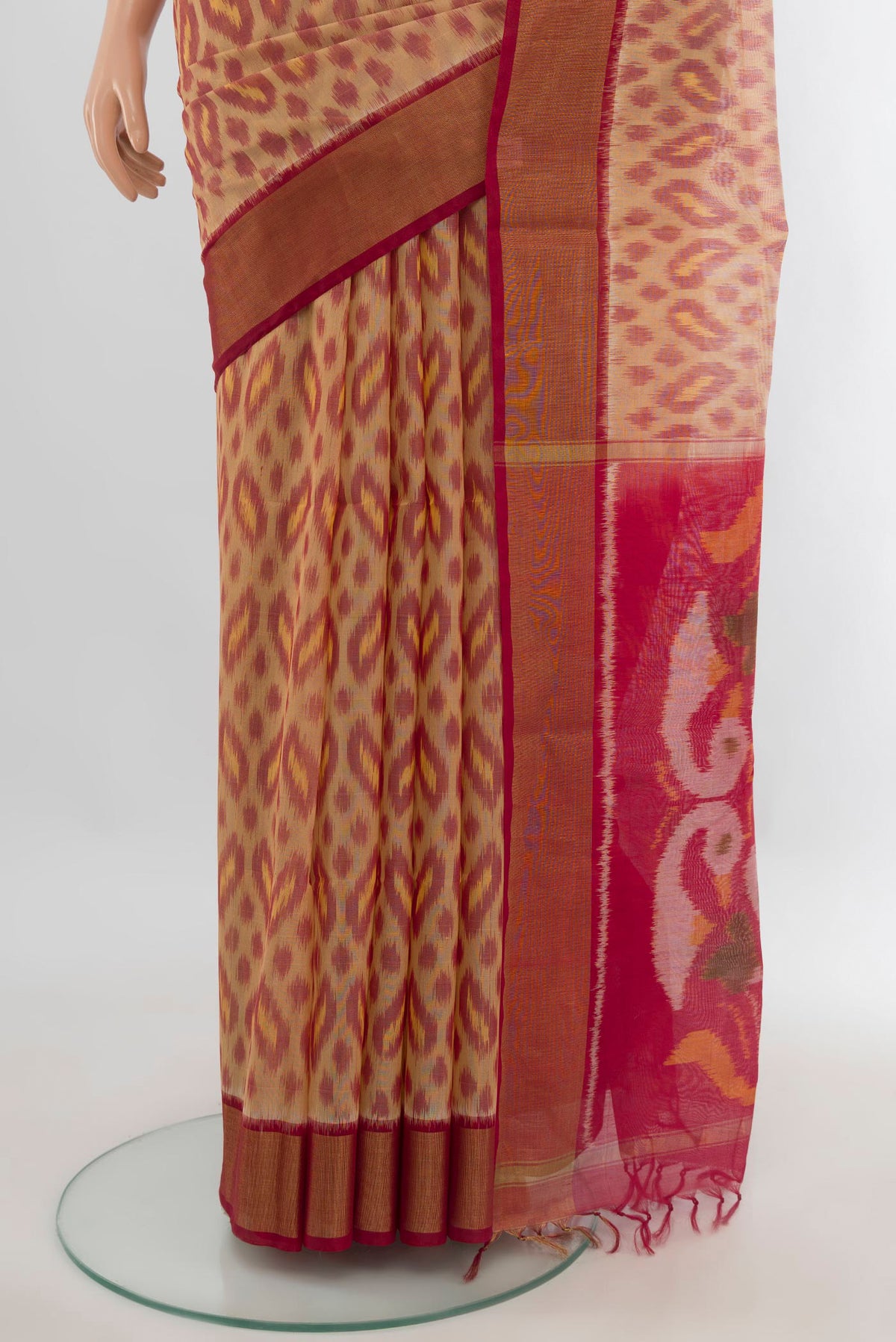 Pleats and pallu of Sandal Silk Cotton Saree with Ikat Print on the body and Zari Border. 