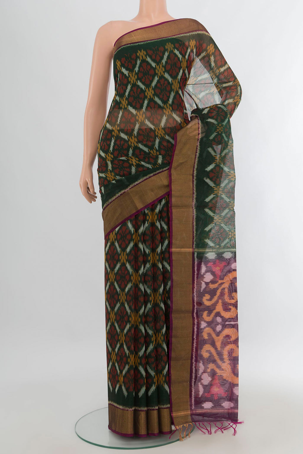 Bottle Green Silk Cotton Saree with Ikat Print on the body and Zari Border.  displayed on a mannequin