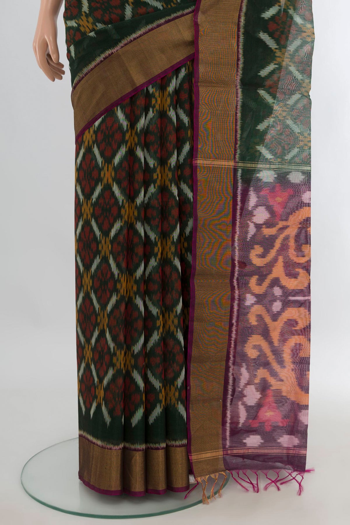 Pleats and pallu of Bottle Green Silk Cotton Saree with Ikat Print on the body and Zari Border. 