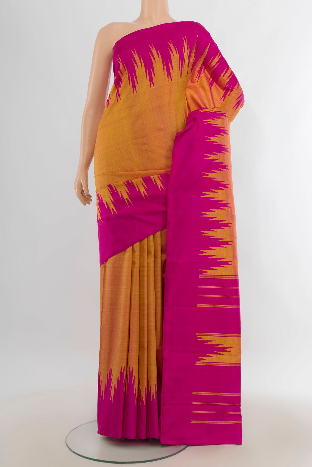 Pure Silk Peach Kanjivaram Saree with Plain Body and Silk Border.  displayed on a mannequin