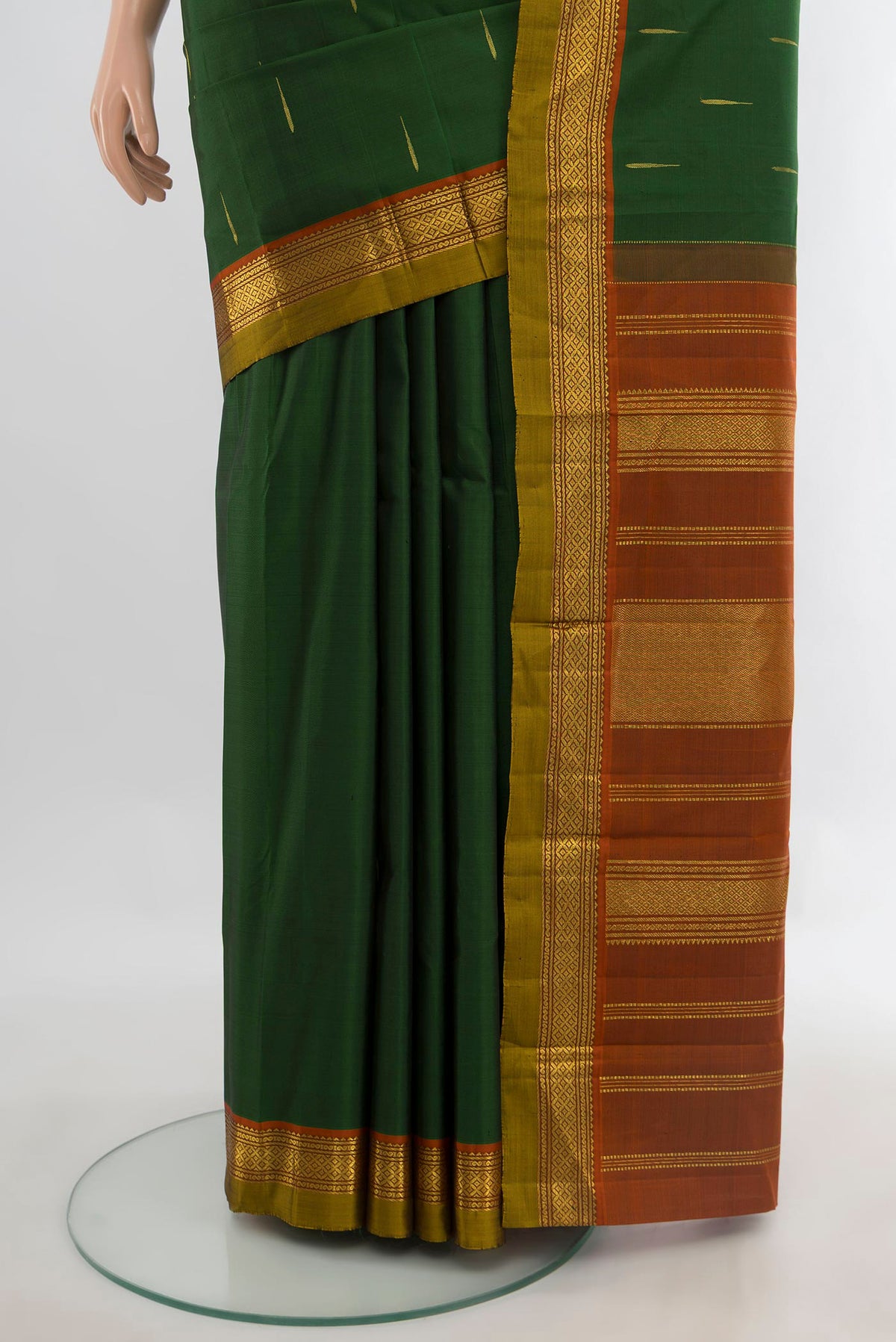 Pleats and pallu of Pure Silk Bottle Green Kanchipuram Saree with Zari Butta on the body and Zari Border. 