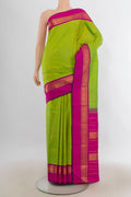 Pure Silk Parrot Green Kanjivaram Saree with Plain Body and Zari Border.  displayed on a mannequin