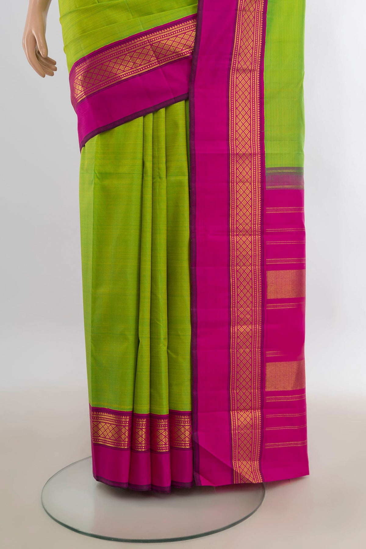 Pleats and pallu of Pure Silk Parrot Green Kanjivaram Saree with Plain Body and Zari Border. 