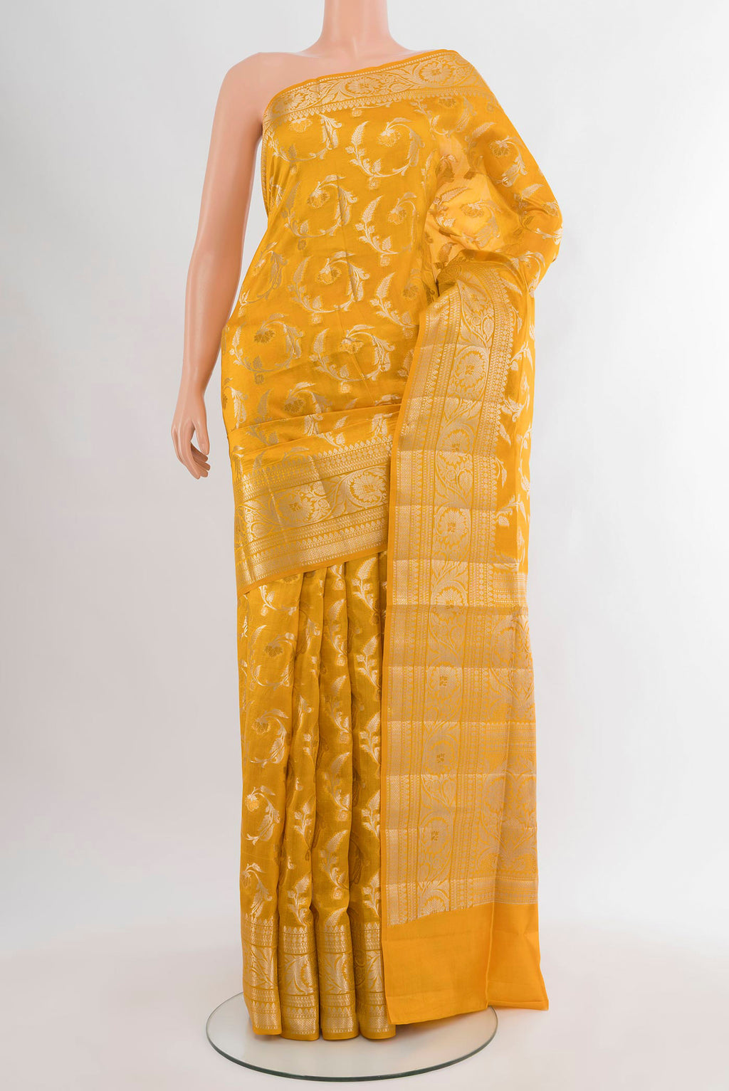 Yellow Banarasi Raw Silk Saree with Zari Butta on the body and Zari Border.  displayed on a mannequin