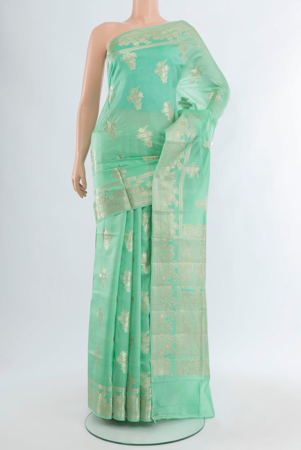 Sea Green Banarasi Raw Silk Saree with Zari Butta on the body and Zari Border.  displayed on a mannequin